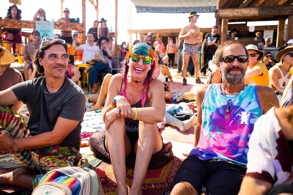 Rocky and Ken smiling at an outdoor festival with their friend Darren